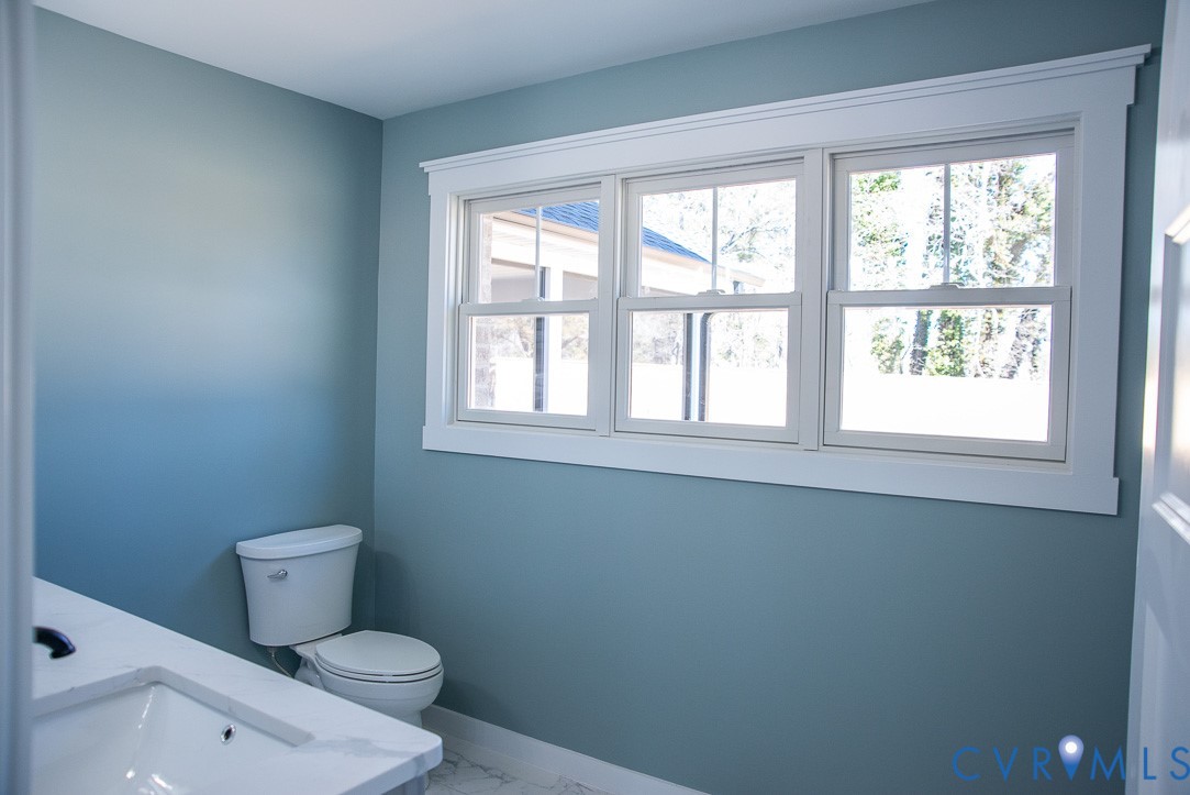 11092 Old Ridge Road Doswell, VA 23047 - Photo 39 of 63 a bathroom with a toilet sink and window