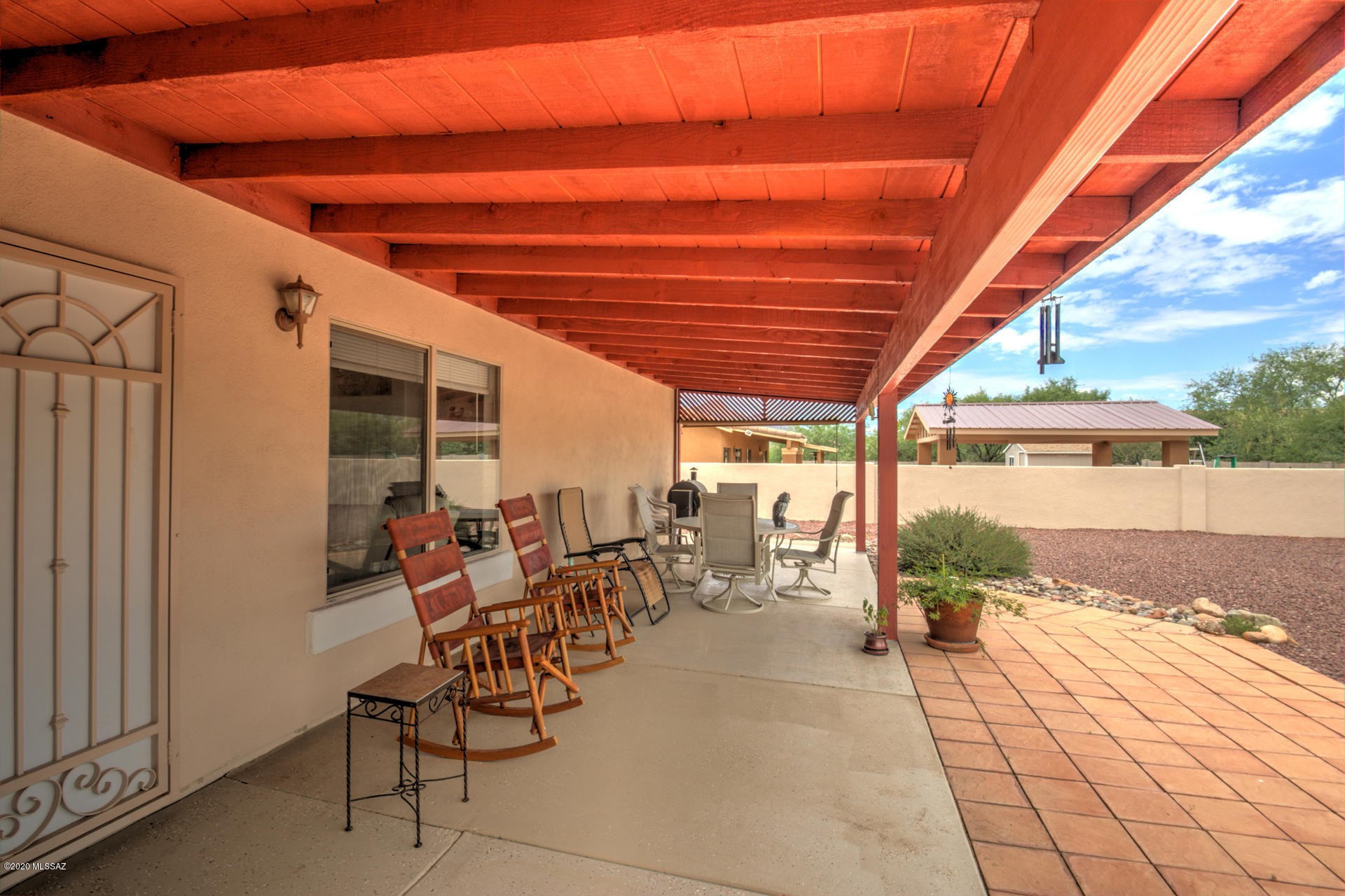 1689 Círculo Alameda Rio Rico, AZ 85648 - Photo 8 of 26 a view of a patio with table and chairs and couches with wooden floor