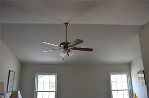 a view of a room with a ceiling fan and a window