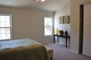 a bedroom with a bed and a table in it