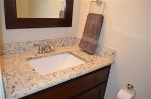 189 Merlin Way Euless, TX 76039 - Photo 18 of 20 a bathroom with a granite countertop sink and a mirror