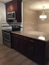 a kitchen with a sink stove and microwave