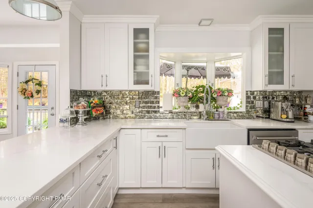 a kitchen with kitchen island granite countertop a sink stainless steel appliances and cabinets