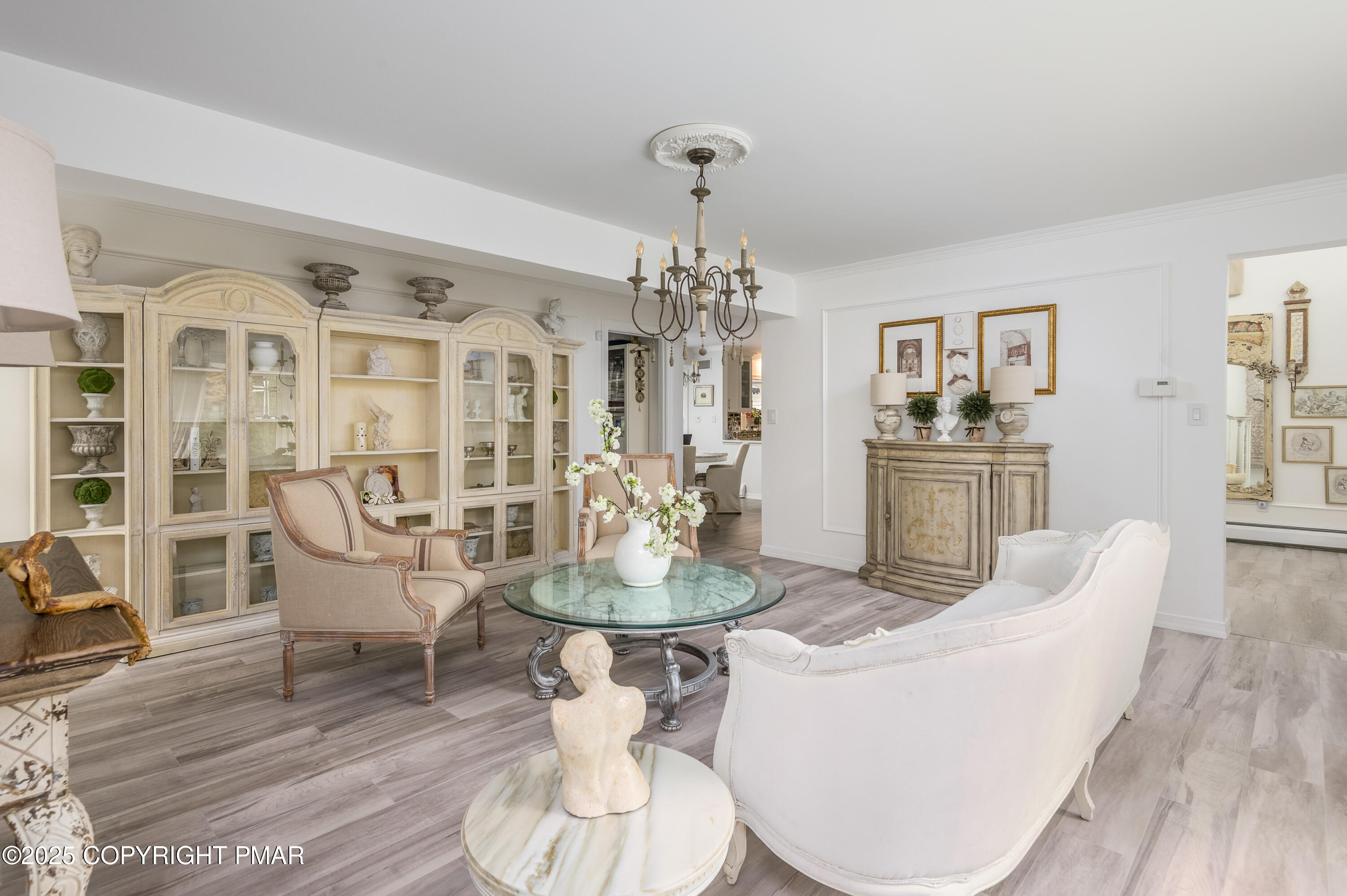 3038 Hemlock Road Stroudsburg, PA 18360 - Photo 13 of 64 a living room with furniture a dining table and a chandelier