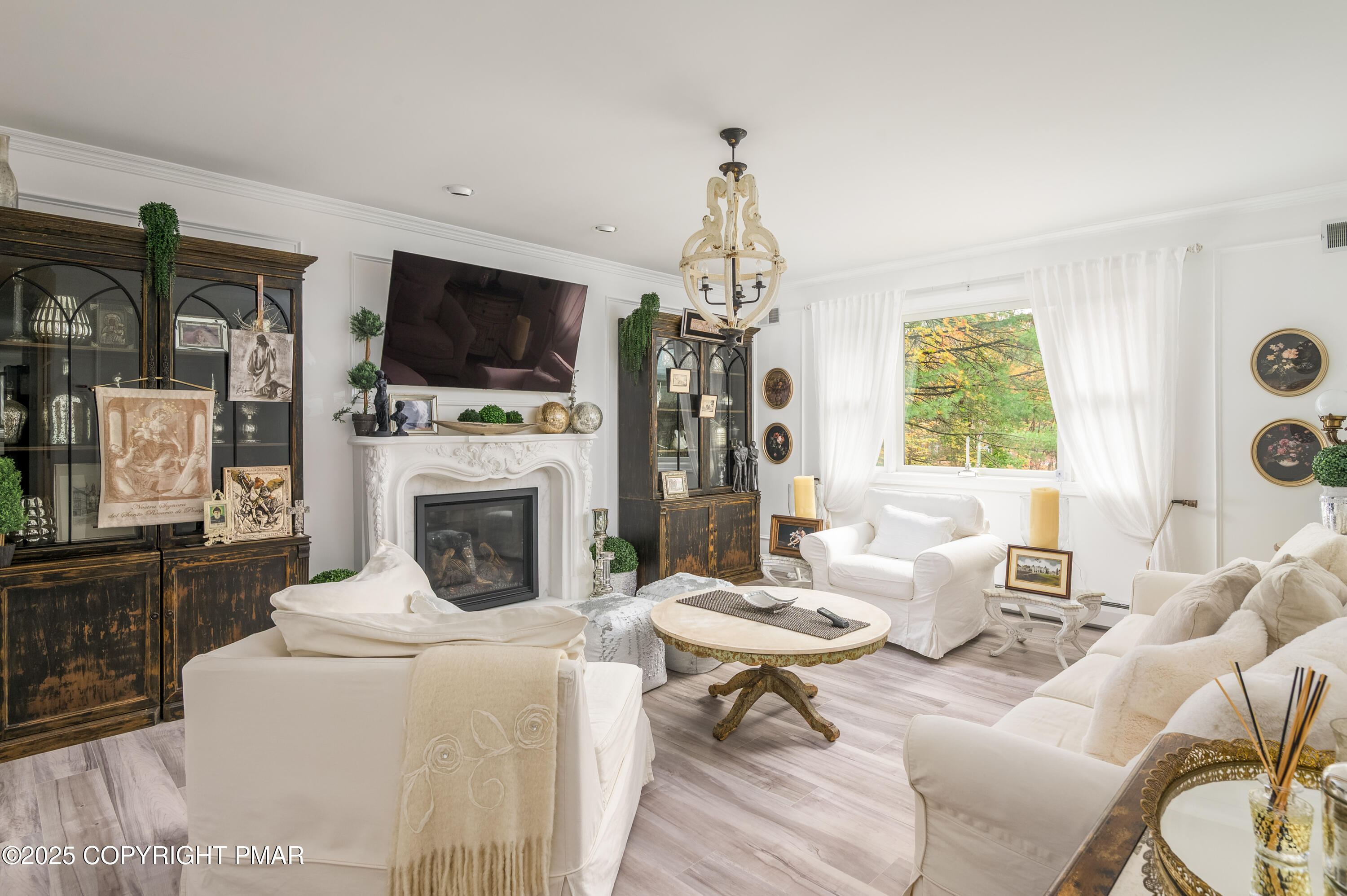 3038 Hemlock Road Stroudsburg, PA 18360 - Photo 19 of 64 a living room with furniture a flat screen tv and a fireplace