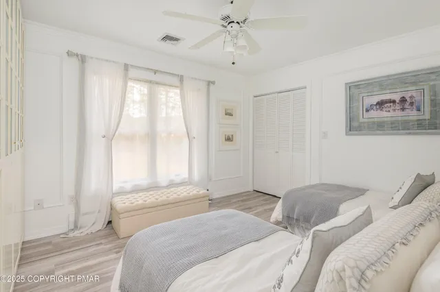 a spacious bedroom with a bed and a chandelier