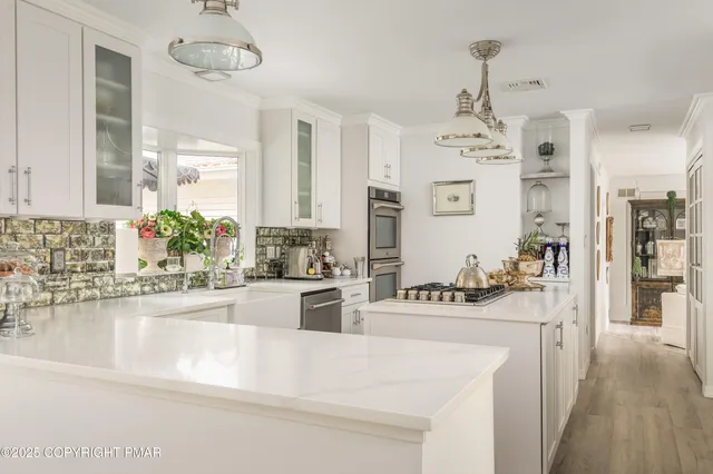 a dining table with chairs and chandelier