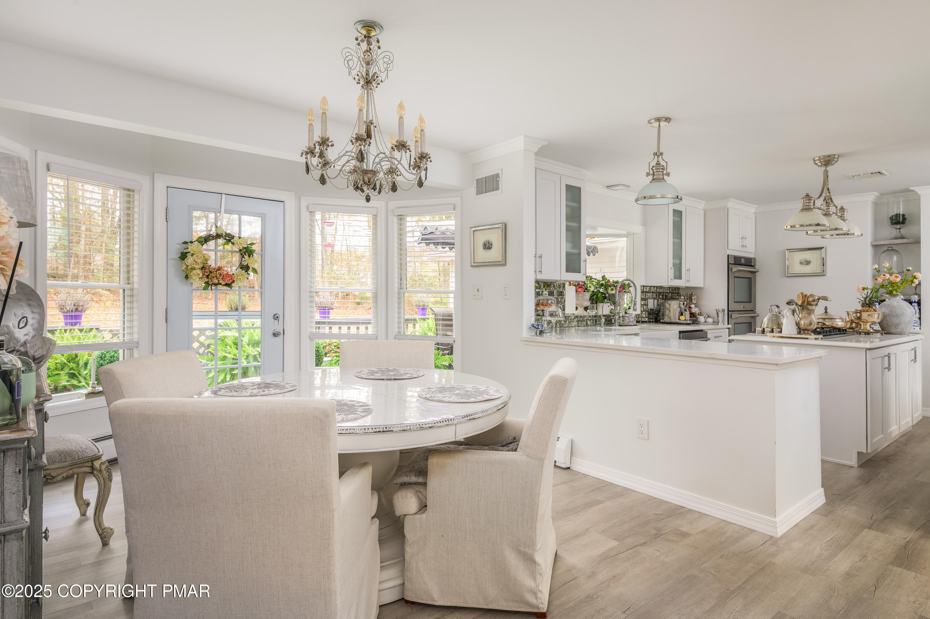3038 Hemlock Road Stroudsburg, PA 18360 - Photo 8 of 64 a dining table with chairs and chandelier