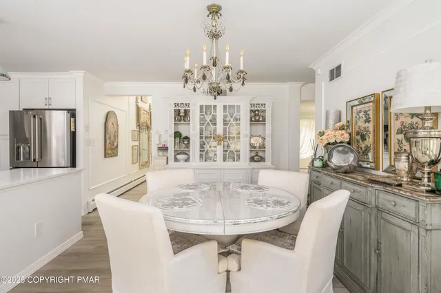 a kitchen with white cabinets and sink