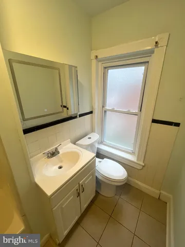 a bathroom with a sink toilet and mirror