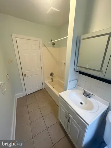 a bathroom with a sink a mirror and shower