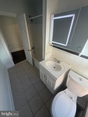 a bathroom with a sink a mirror and a toilet