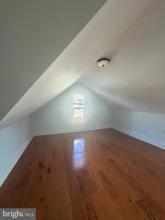 a view of an empty room and wooden floor