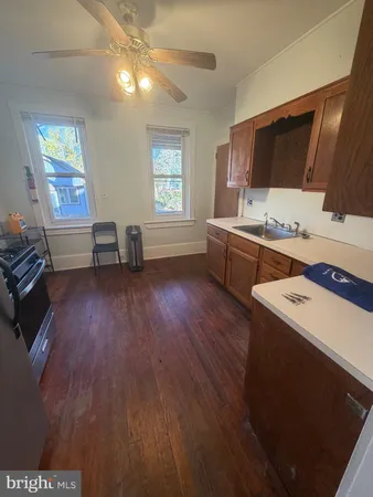 a kitchen that has a sink and a stove in it