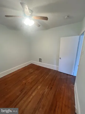 a view of room with wooden floor