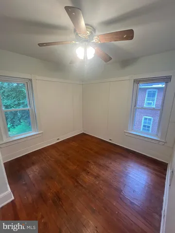 a view of empty room with wooden floor