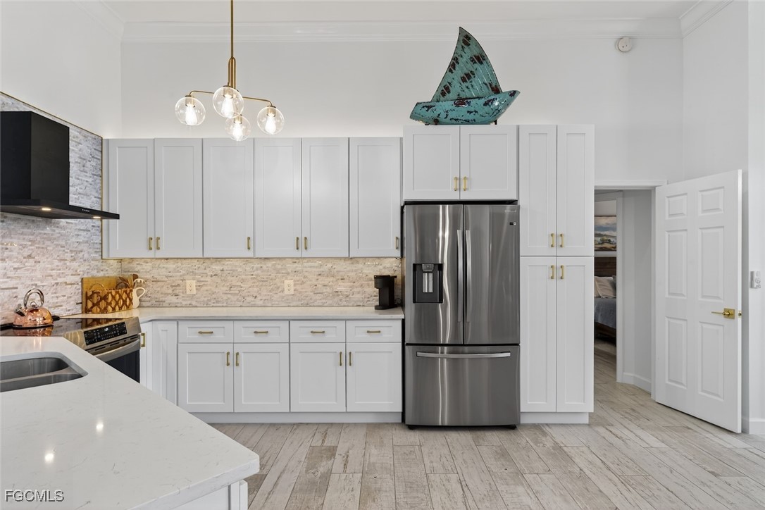 13570 Harbour Ridge Drive Fort Myers, FL 33908 - Photo 15 of 50 a kitchen with kitchen island a counter top space stainless steel appliances and cabinets