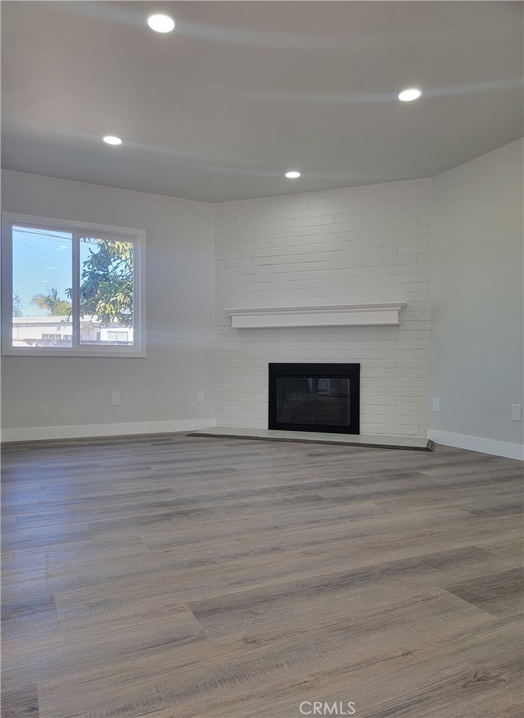 1637 Highland Street Santa Ana, CA 92703 - Photo 4 of 15 a view of empty room with wooden floor and fireplace