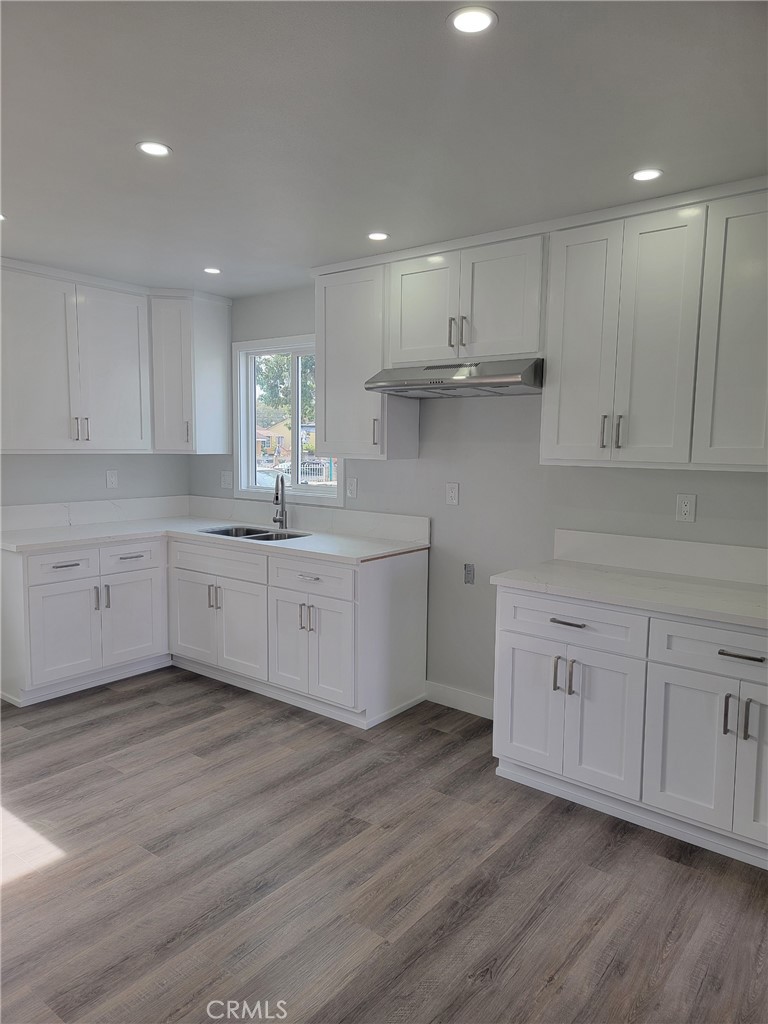1637 Highland Street Santa Ana, CA 92703 - Photo 6 of 15 a kitchen with white cabinets stainless steel appliances and sink