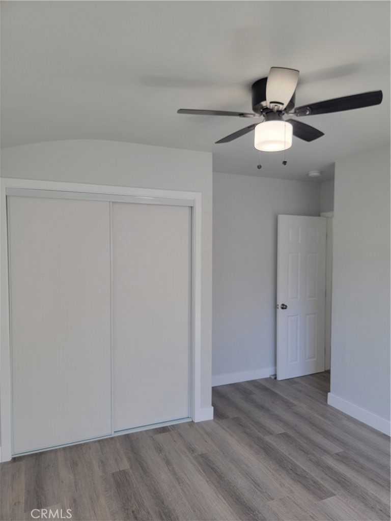 1637 Highland Street Santa Ana, CA 92703 - Photo 10 of 15 an empty room with wooden floor fan and windows