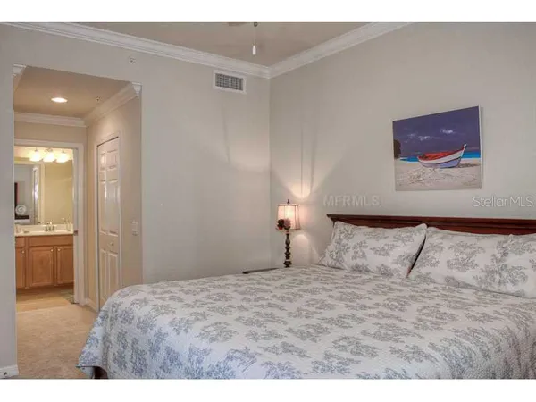 a bedroom with a bed and a view of bathroom