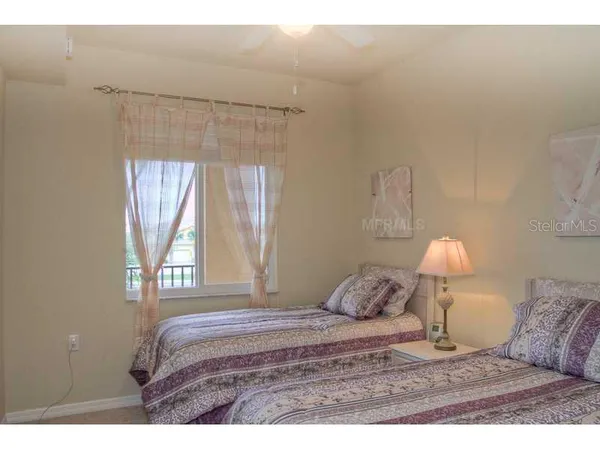 a bedroom with a bed and a lamp