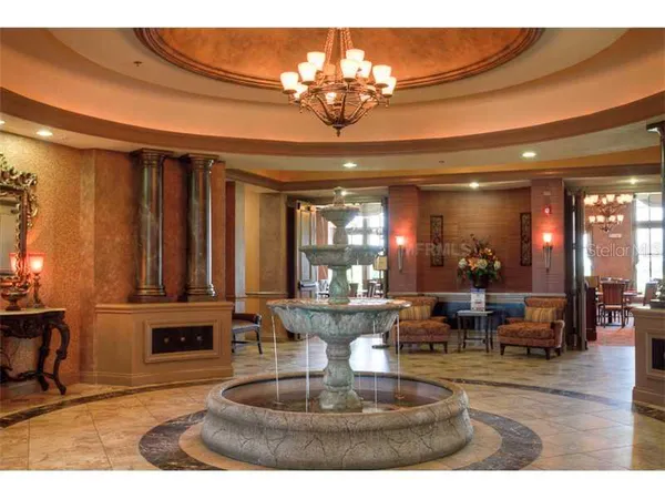 a living room with fireplace furniture and a chandelier