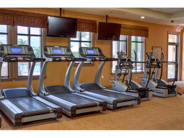 a room with gym equipment and windows