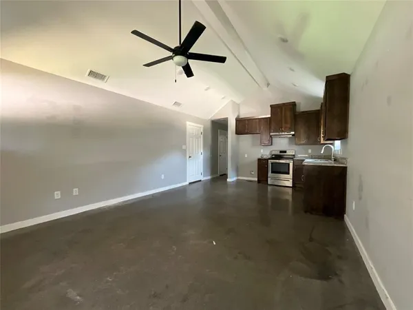 a view of a kitchen with a sink wooden floor and a ceiling fan