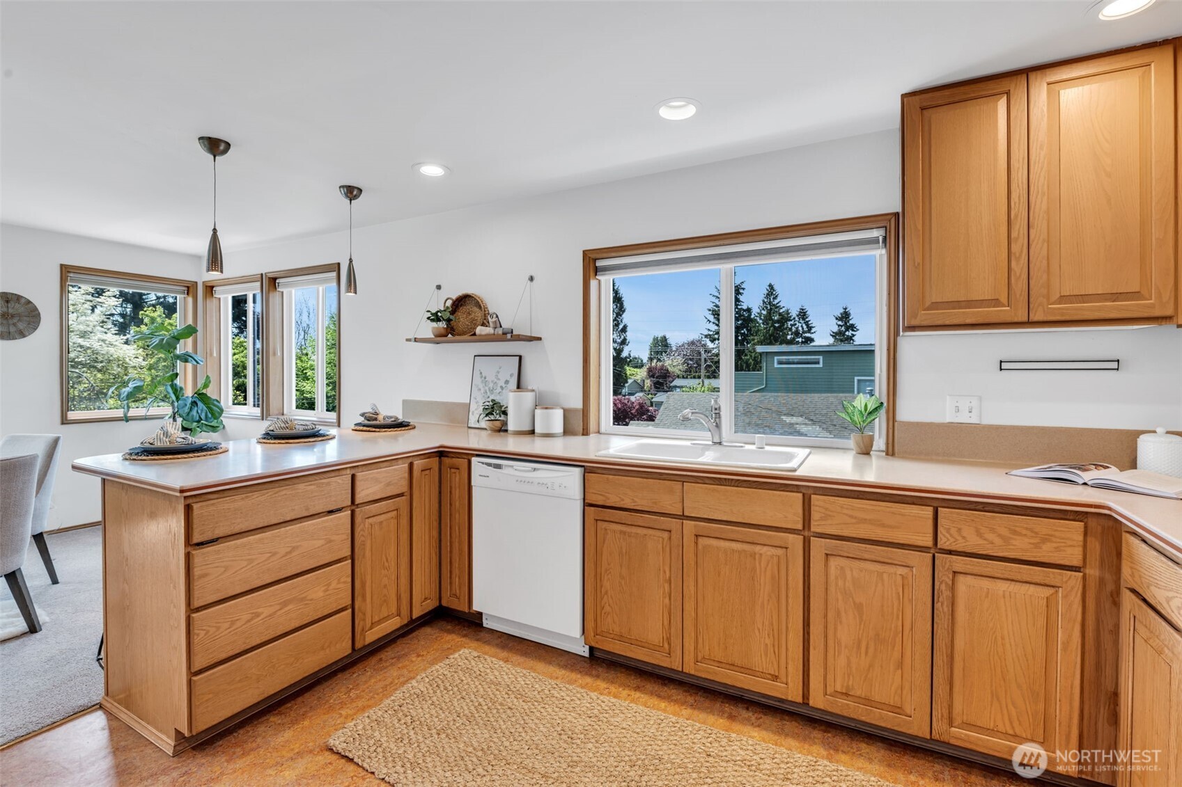 722 North 92nd Street, Unit 1 Seattle, WA 98103 - Photo 11 of 33 a kitchen with granite countertop white cabinets and a large window