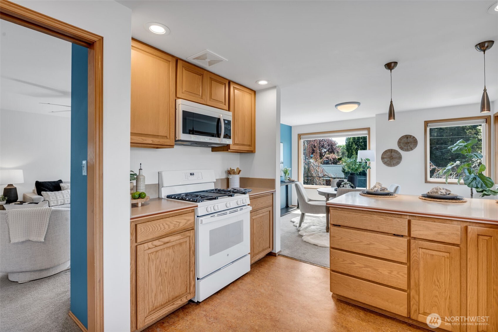 722 North 92nd Street, Unit 1 Seattle, WA 98103 - Photo 12 of 33 a kitchen with stainless steel appliances granite countertop a stove a sink and a microwave