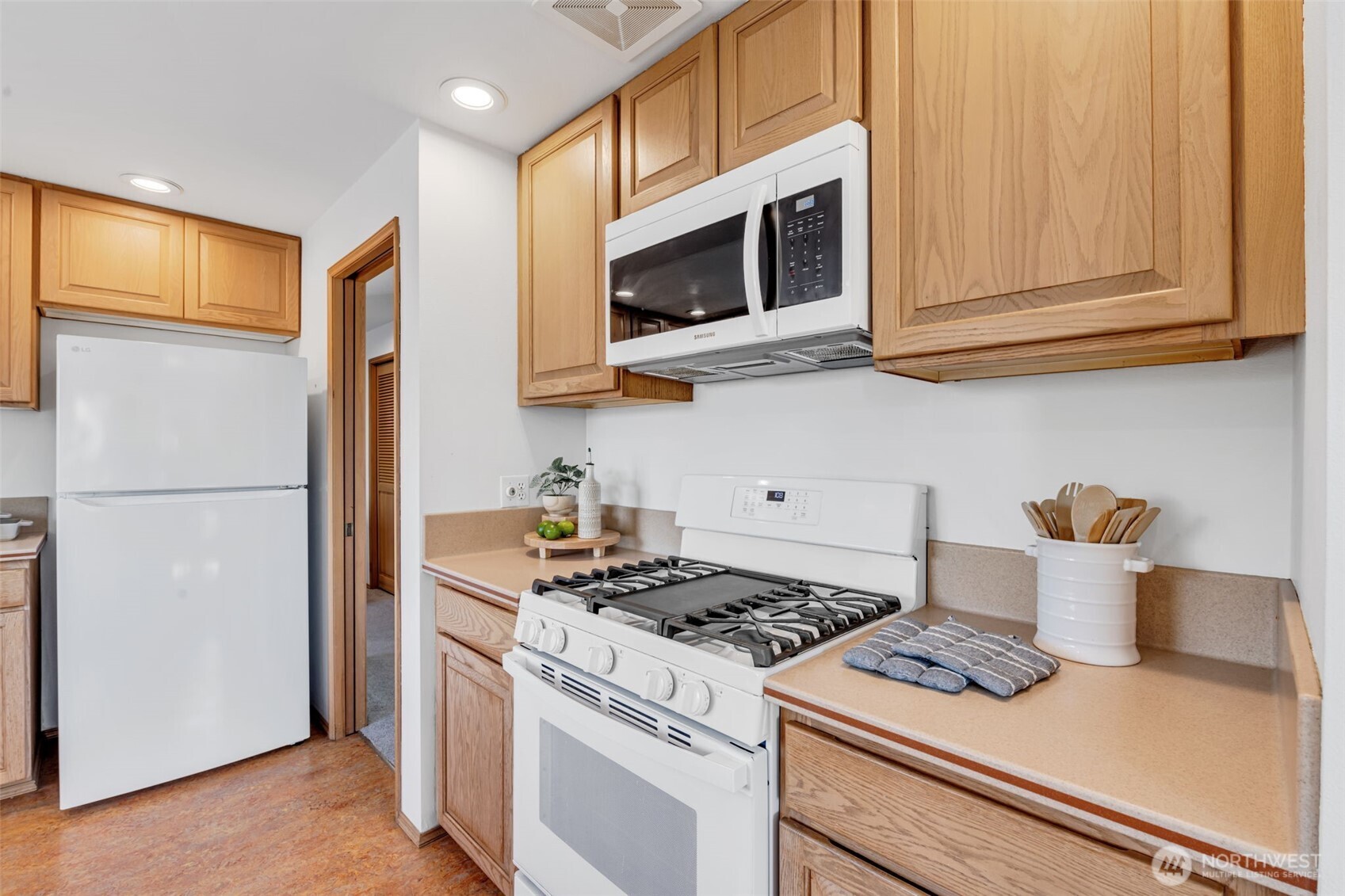 722 North 92nd Street, Unit 1 Seattle, WA 98103 - Photo 13 of 33 a kitchen with stainless steel appliances granite countertop white cabinets and a stove top oven