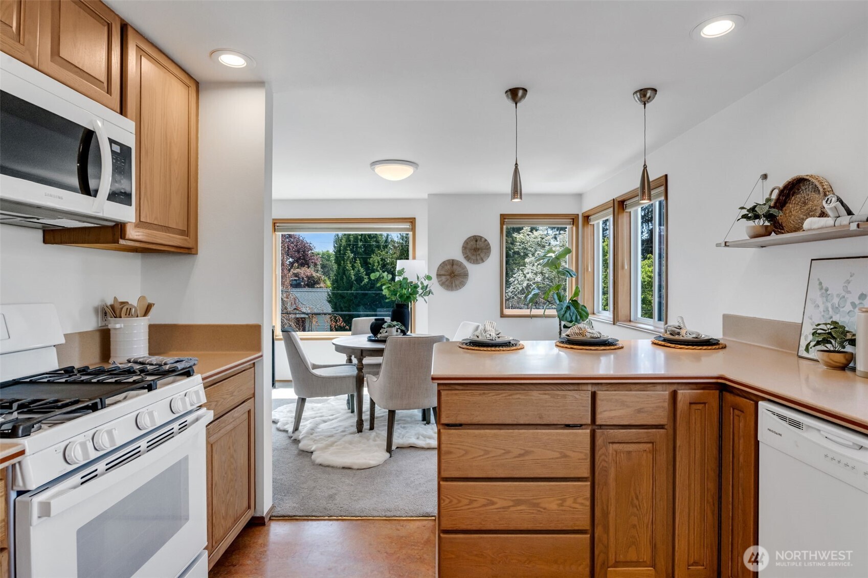 722 North 92nd Street, Unit 1 Seattle, WA 98103 - Photo 14 of 33 a kitchen with a sink stove and microwave