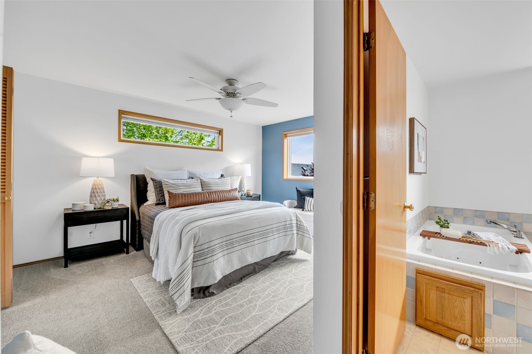 722 North 92nd Street, Unit 1 Seattle, WA 98103 - Photo 16 of 33 a bedroom with a bed and a chandelier