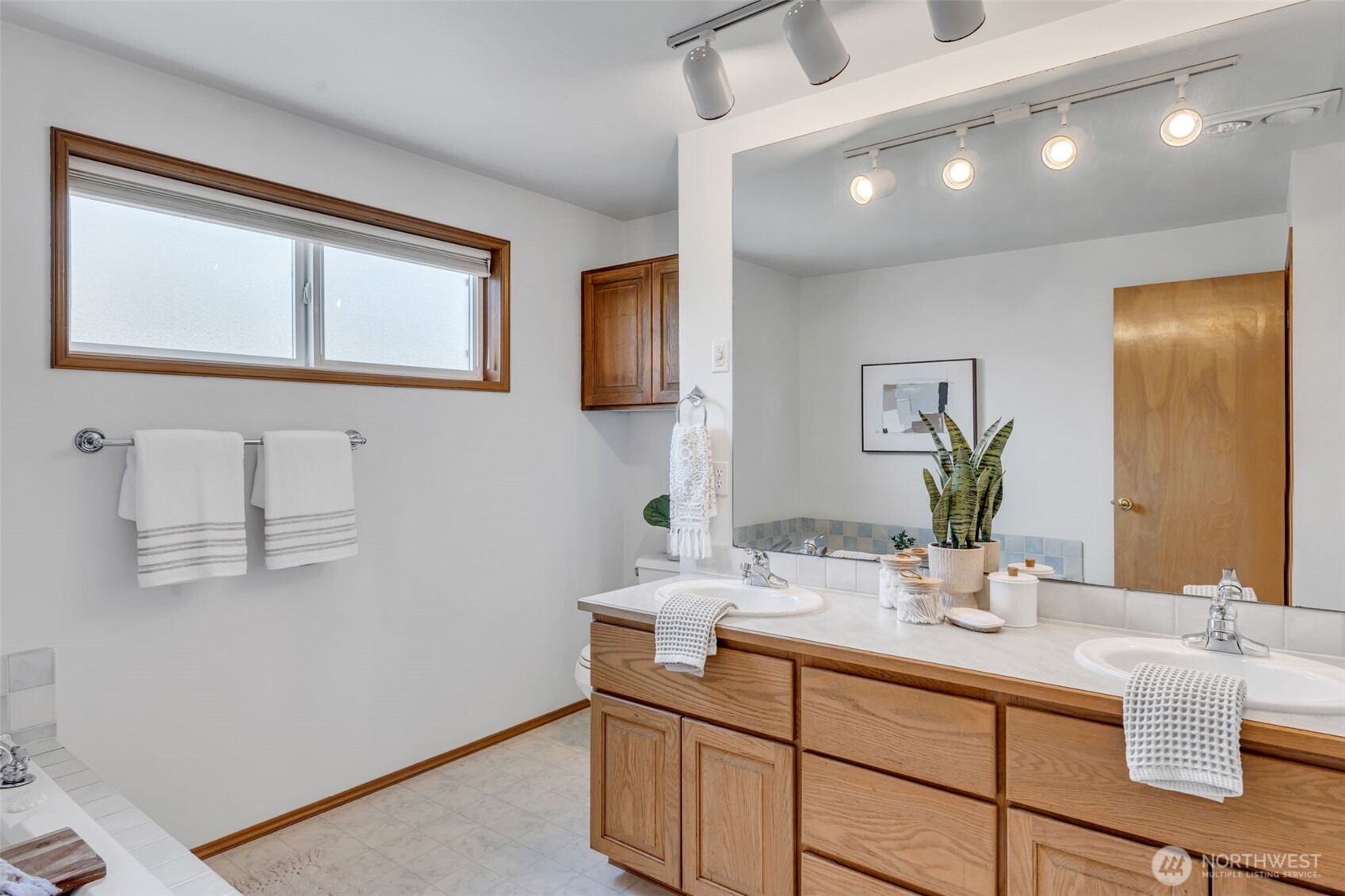 722 North 92nd Street, Unit 1 Seattle, WA 98103 - Photo 19 of 33 a bathroom with a sink and a mirror
