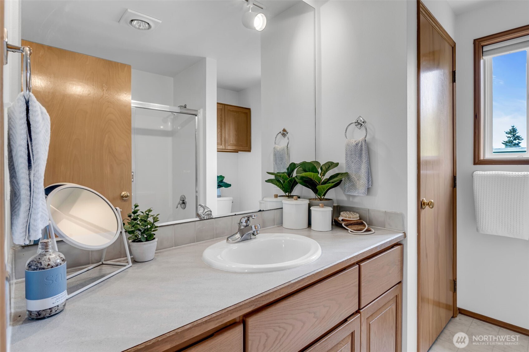722 North 92nd Street, Unit 1 Seattle, WA 98103 - Photo 23 of 33 a bathroom with a sink a light fixture and a mirror