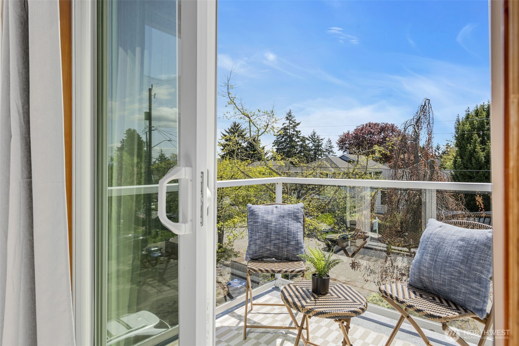 722 North 92nd Street, Unit 1 Seattle, WA 98103 - Photo 24 of 33 a view of a chairs and table in patio with a lake view