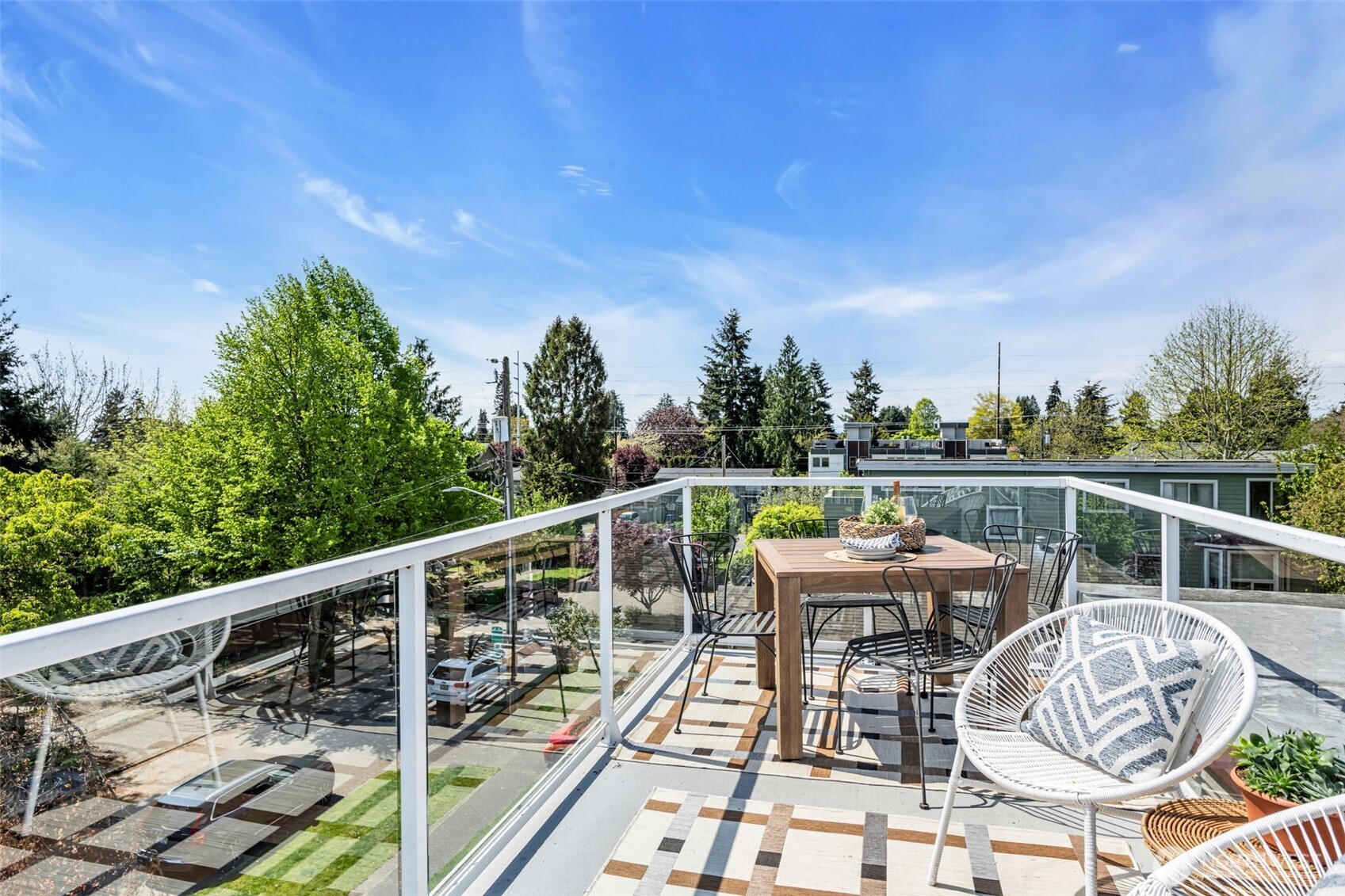 722 North 92nd Street, Unit 1 Seattle, WA 98103 - Photo 28 of 33 a balcony with wooden floor table and chairs