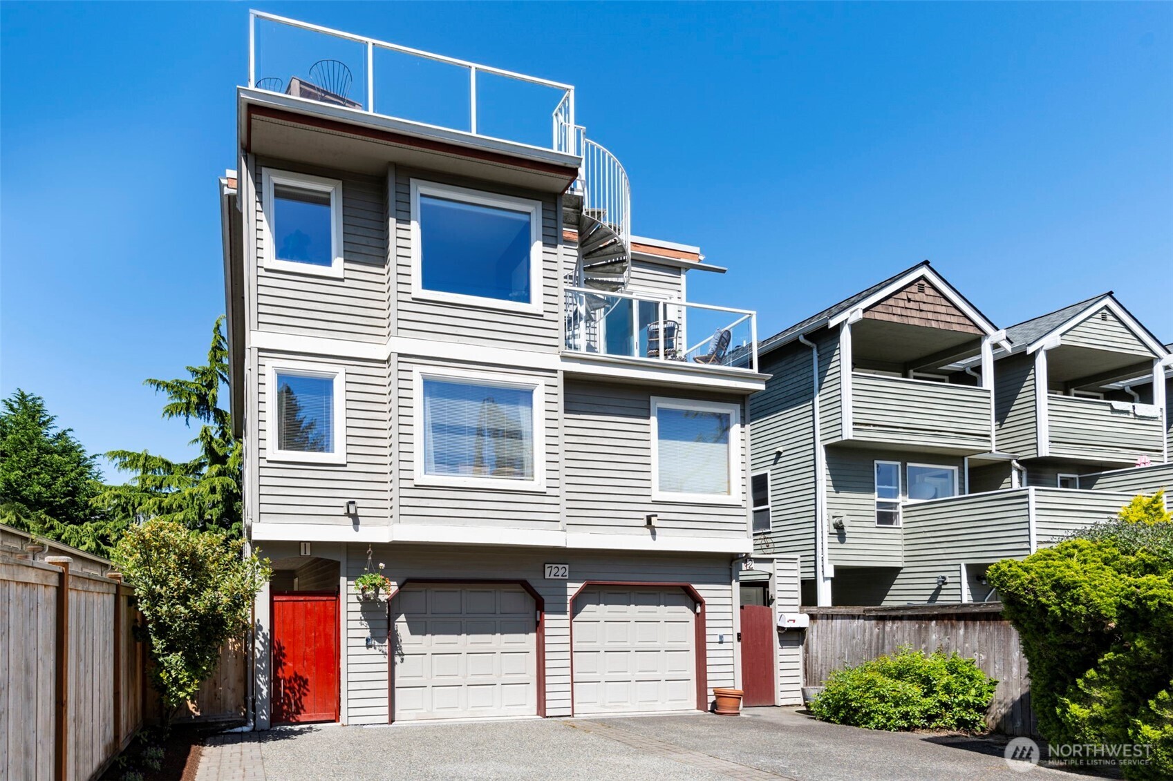 722 North 92nd Street, Unit 1 Seattle, WA 98103 - Photo 29 of 33 a front view of a house with garage and trees