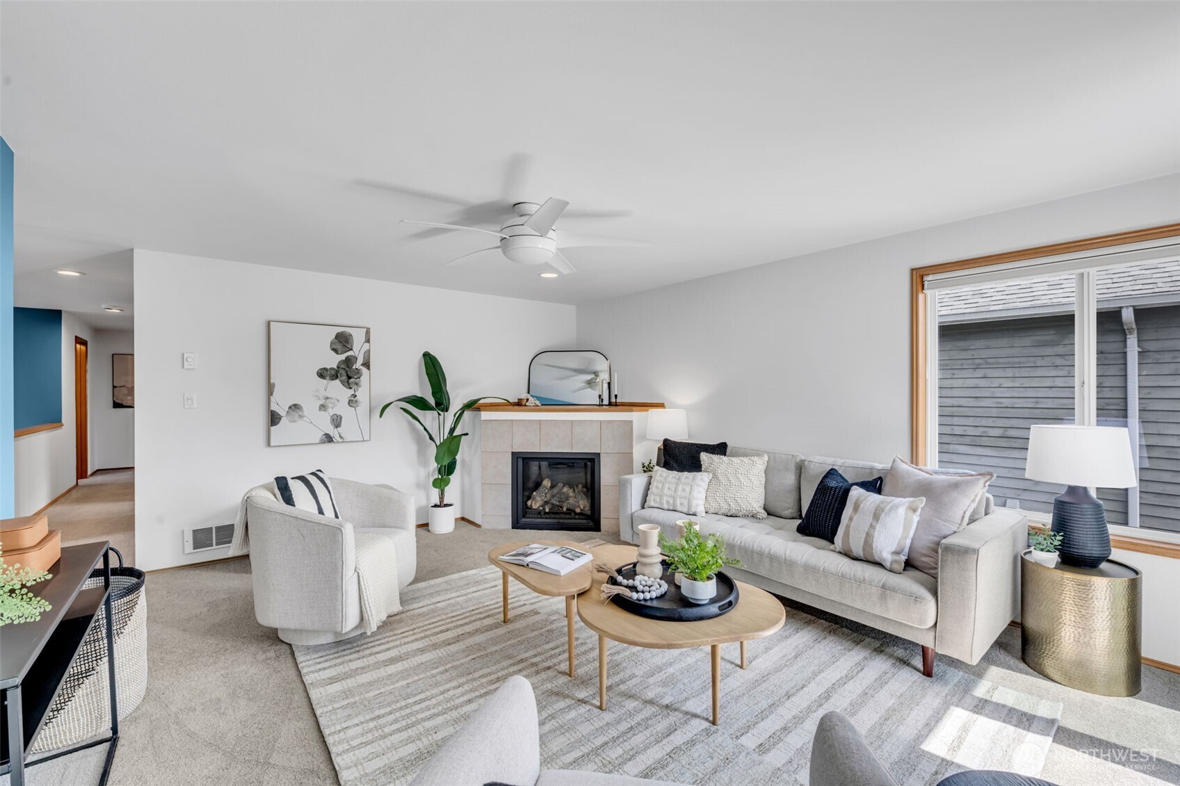 722 North 92nd Street, Unit 1 Seattle, WA 98103 - Photo 5 of 33 a living room with furniture a fireplace and a table