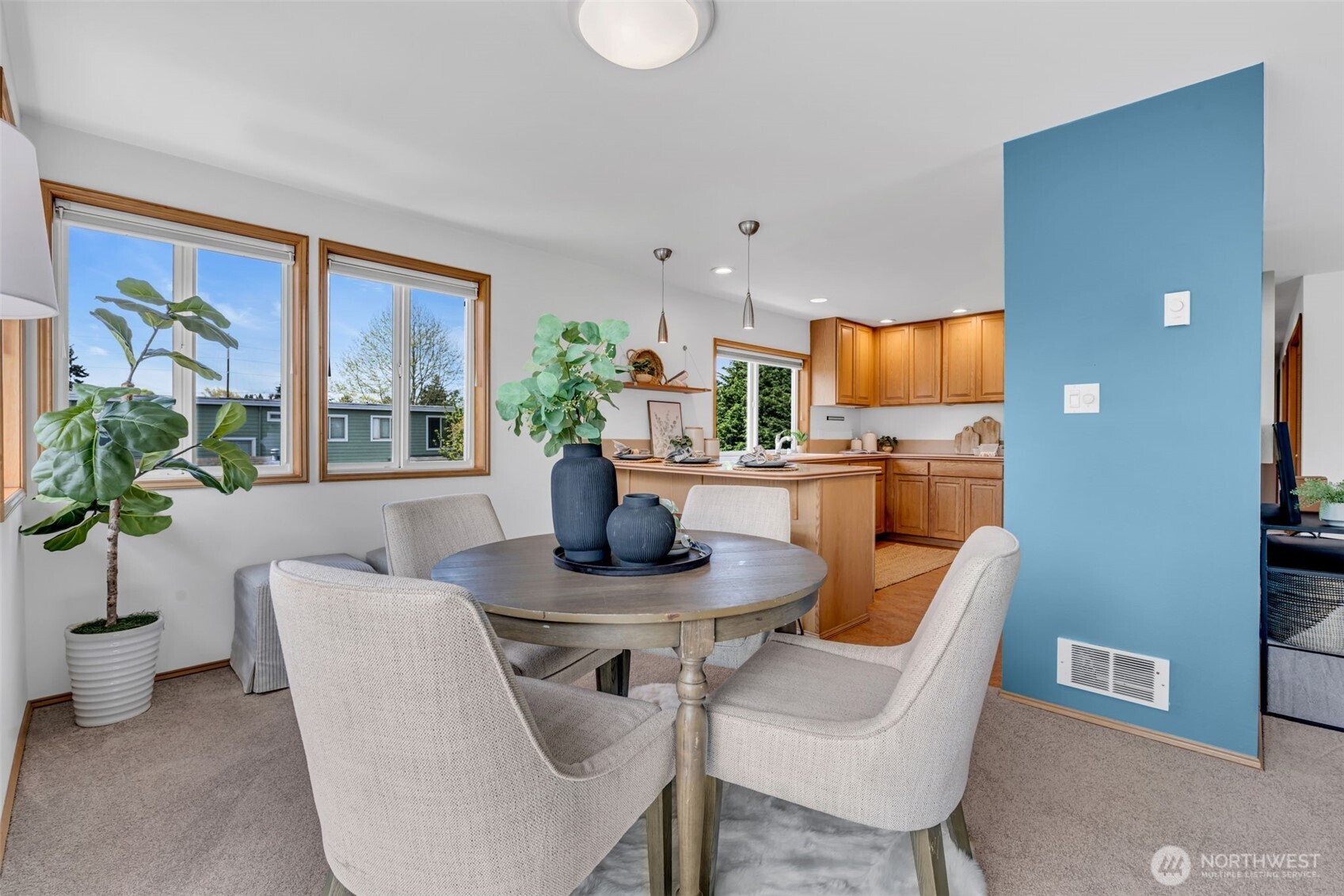 722 North 92nd Street, Unit 1 Seattle, WA 98103 - Photo 8 of 33 a dining room with furniture a potted plant and a window