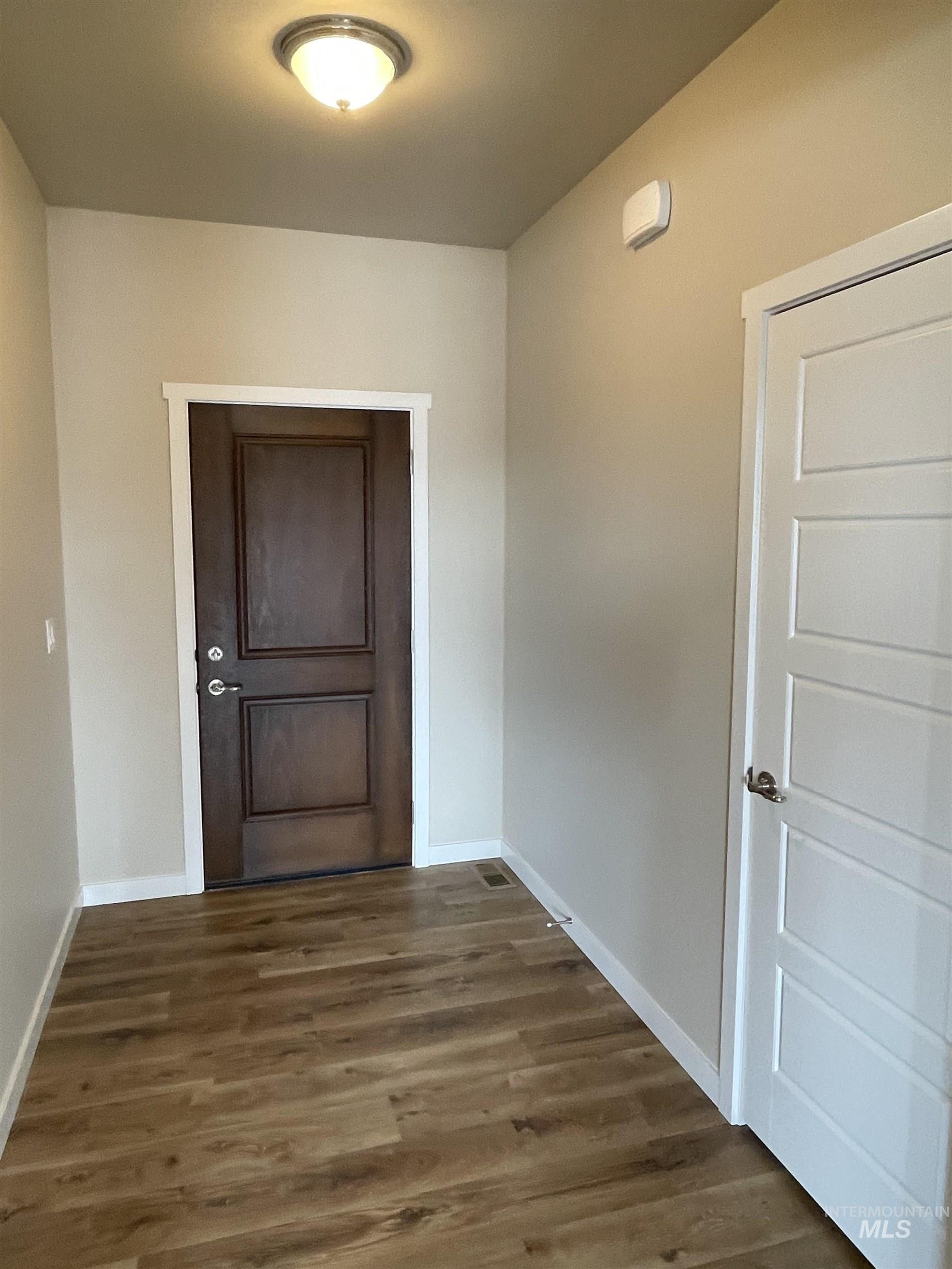 961 Quartz Road Kimberly, ID 83341 - Photo 12 of 19 Hallway with dark wood-style flooring and baseboards