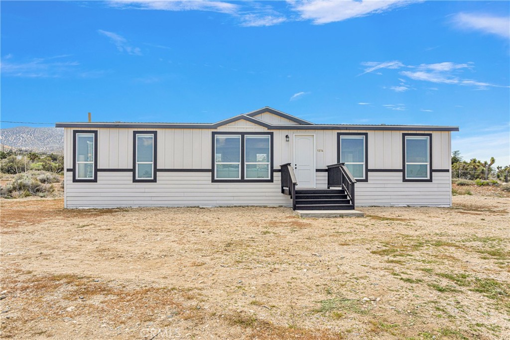 9374 Spruce Road Pinon Hills, CA 92372 - Photo 1 of 1 a front view of a house with a yard