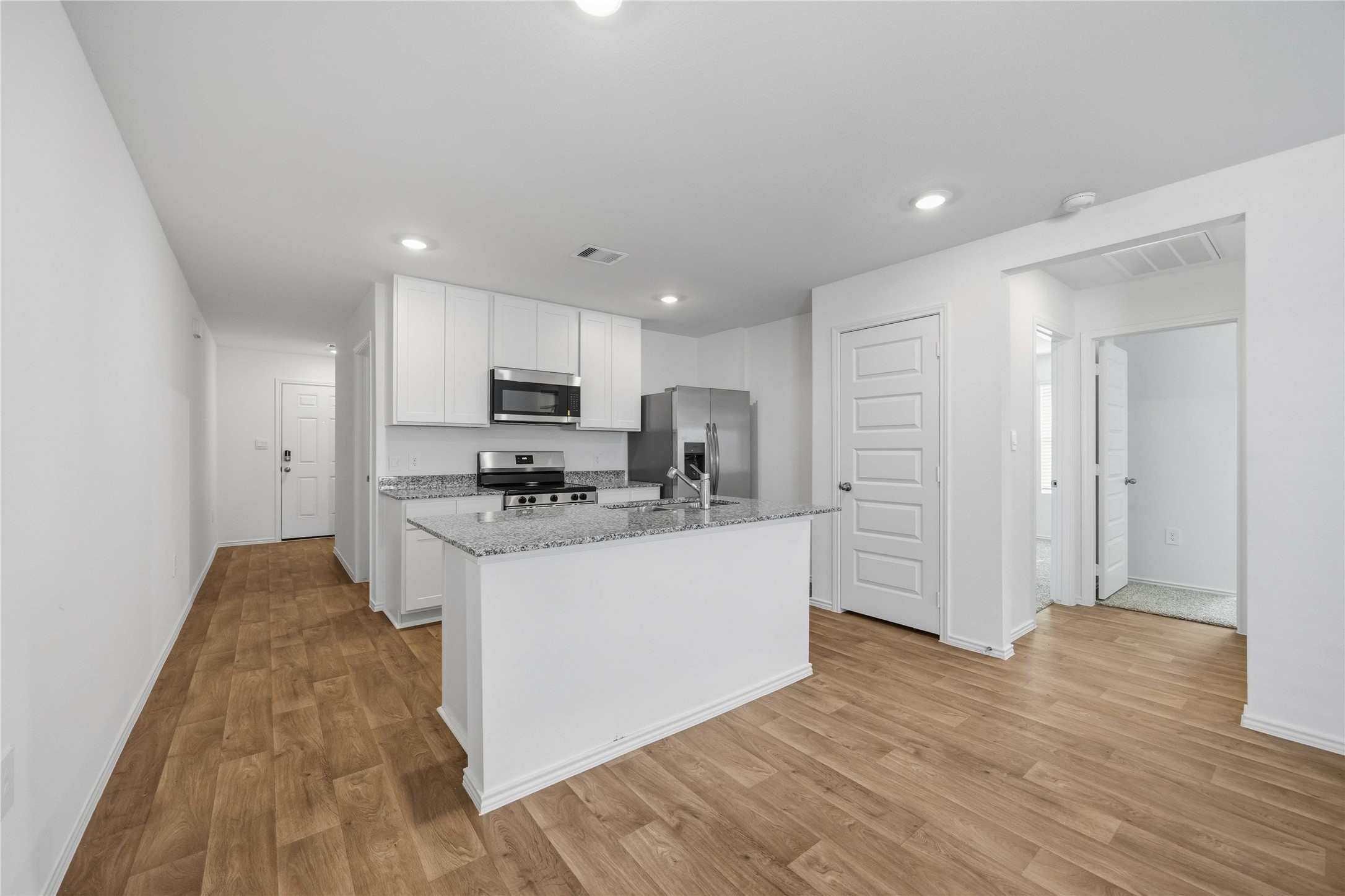 11908 Lilac Ice Lane Houston, TX 77048 - Photo 6 of 16 a kitchen with stainless steel appliances granite countertop a stove top oven a sink and a refrigerator