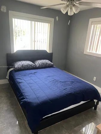 a bed sitting in a bedroom next to a window