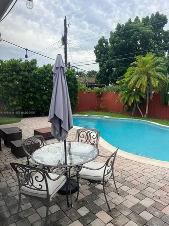 a view of a patio with table and chairs and potted plants