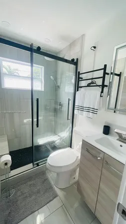 a bathroom with a toilet and a shower