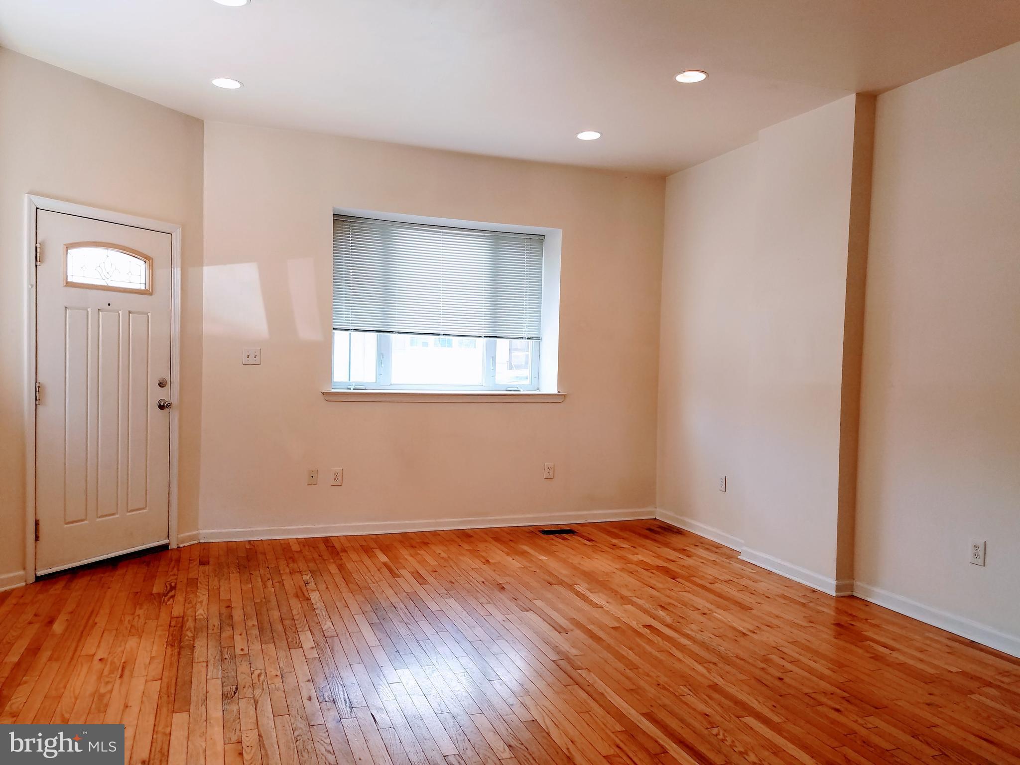 1951 South 4th Street, Unit 1 Philadelphia, PA 19148 - Photo 4 of 8 an empty room with wooden floor and windows