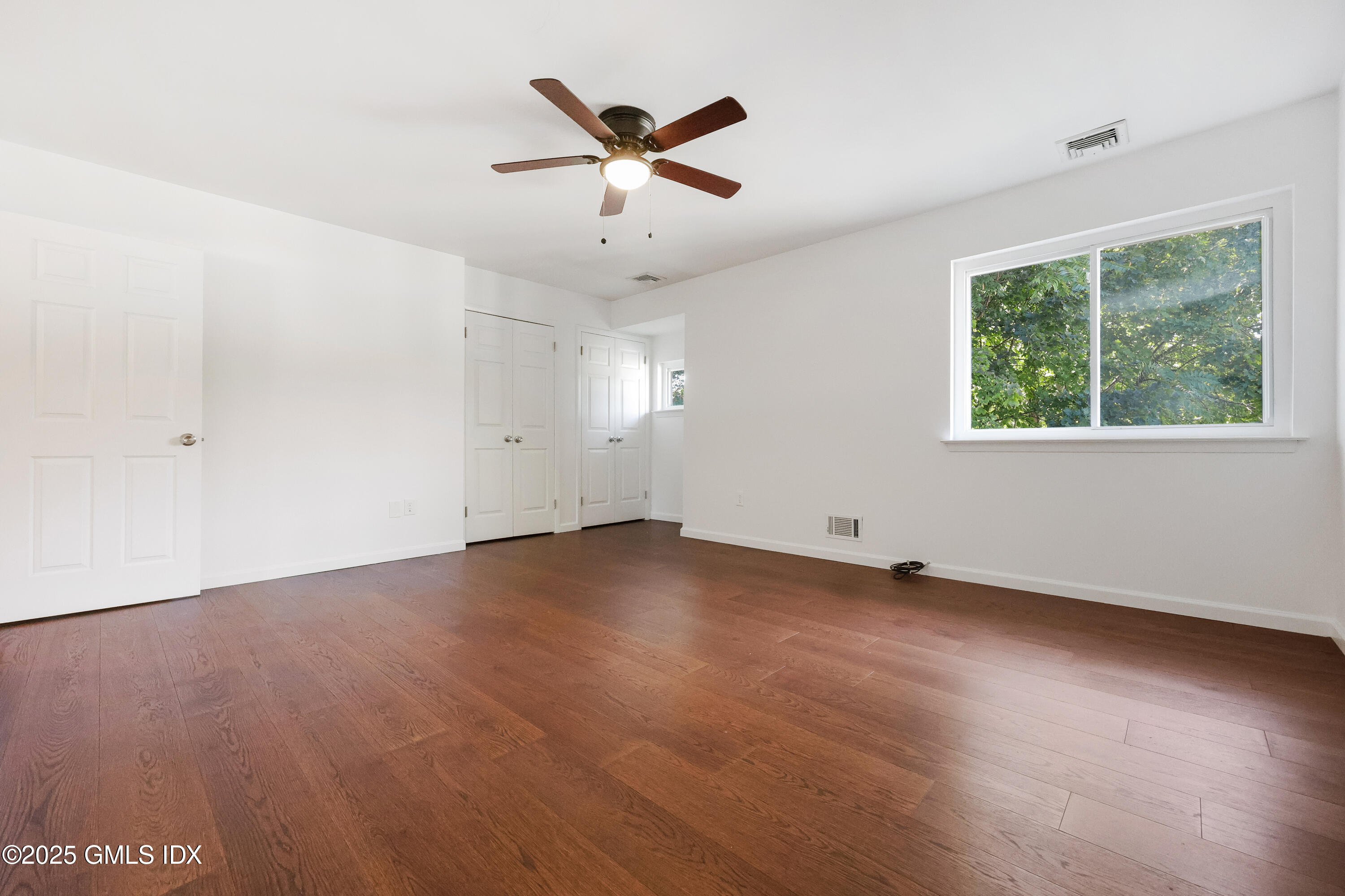 75 Cos Cob Avenue, Unit 14 Cos Cob, CT 06807 - Photo 15 of 28 an empty room with ceiling fan and windows