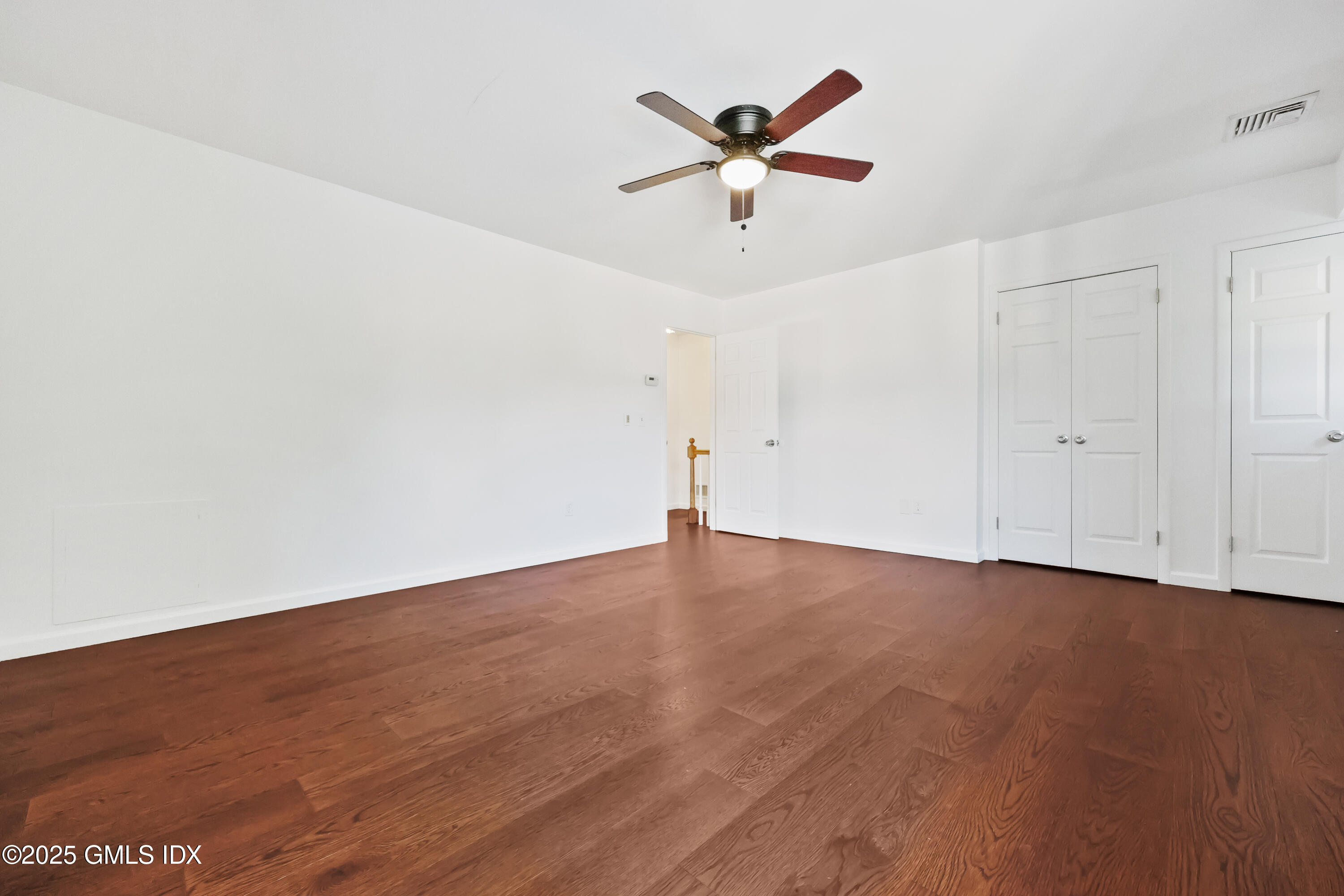 75 Cos Cob Avenue, Unit 14 Cos Cob, CT 06807 - Photo 16 of 28 an empty room with wooden floor and windows